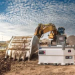 Western Global TransCube fuel storage tank with an open equipment cabinet beside an excavator at a construction site.